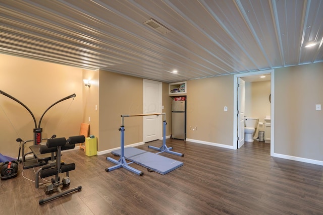 workout area featuring visible vents, recessed lighting, dark wood-style floors, and baseboards