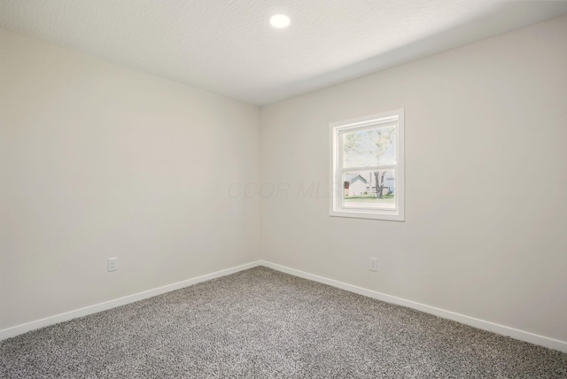 carpeted spare room with recessed lighting and baseboards