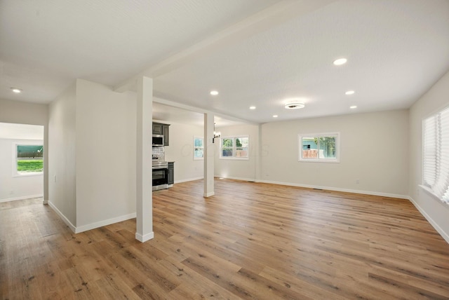 below grade area with light wood-type flooring, recessed lighting, and baseboards