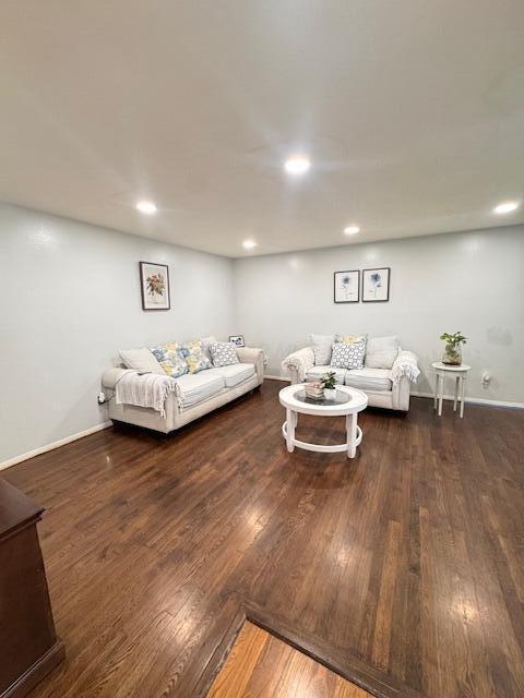 living room with wood finished floors, baseboards, and recessed lighting