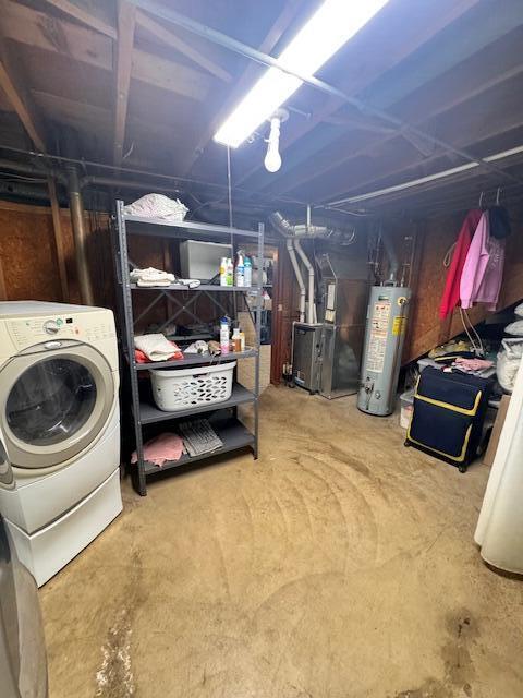 unfinished basement featuring washer / dryer, gas water heater, and heating unit