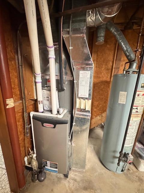 utility room with gas water heater and heating unit