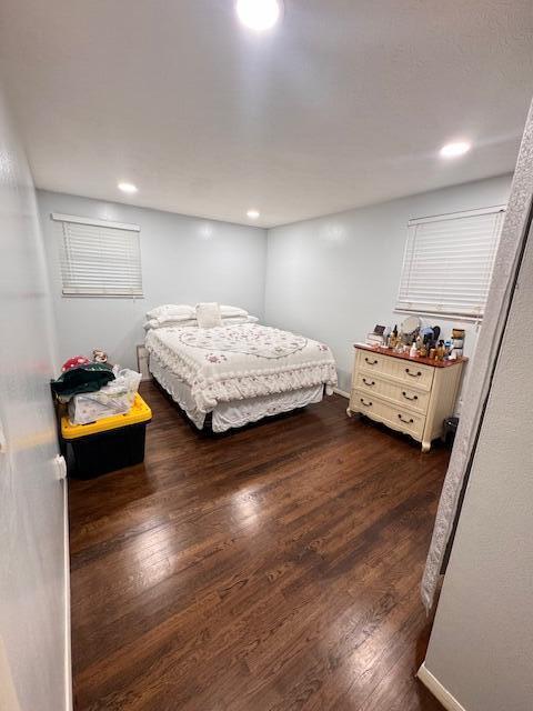bedroom featuring dark wood-style floors and recessed lighting