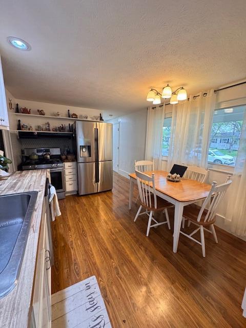dining room with wood finished floors and a textured ceiling