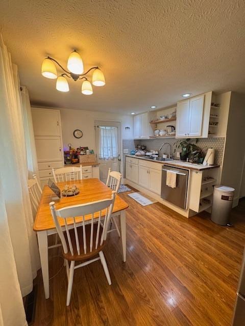dining area with wood finished floors, a textured ceiling, and recessed lighting