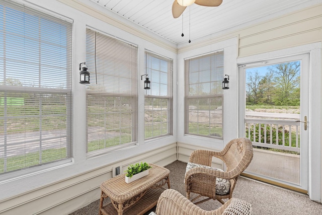sunroom with crown molding and carpet