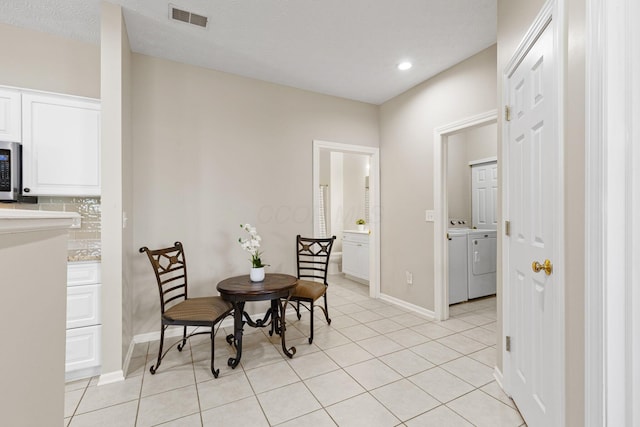 dining area with visible vents, washing machine and dryer, baseboards, recessed lighting, and light tile patterned floors