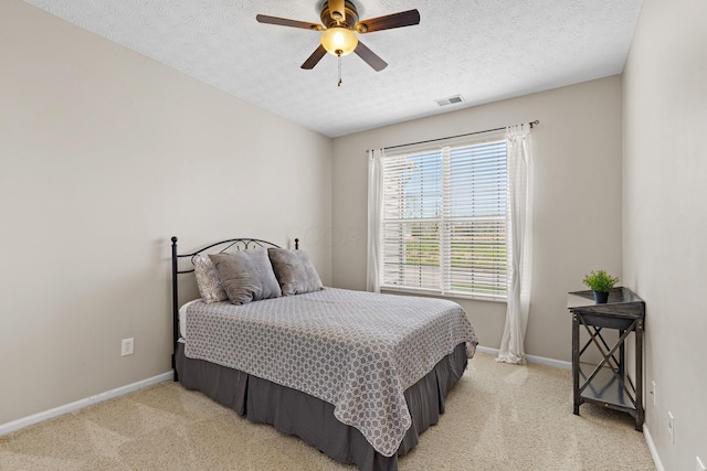 bedroom with baseboards, light carpet, and visible vents