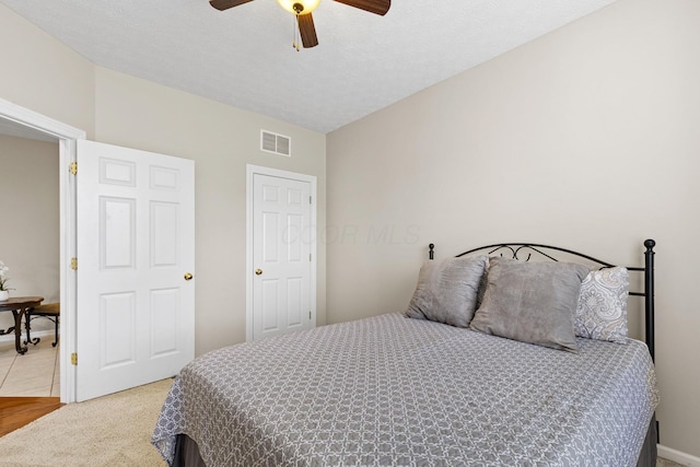 bedroom featuring visible vents, a ceiling fan, and carpet flooring