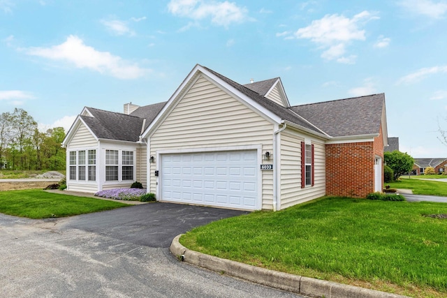view of front facade featuring a garage, a front lawn, driveway, and a shingled roof