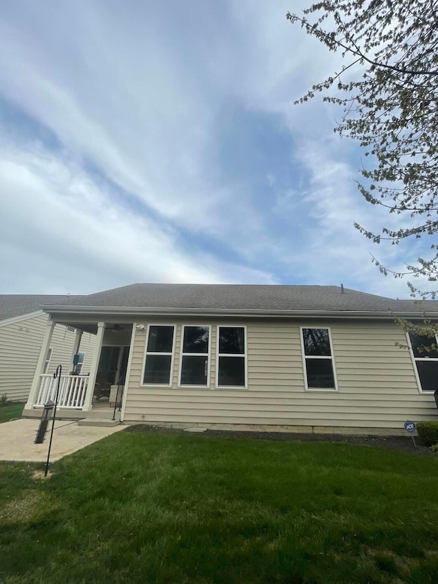 back of house featuring a yard and a patio