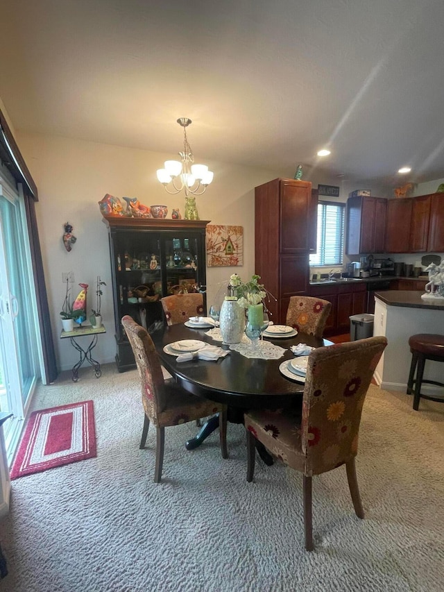 dining area featuring light colored carpet, recessed lighting, and a notable chandelier