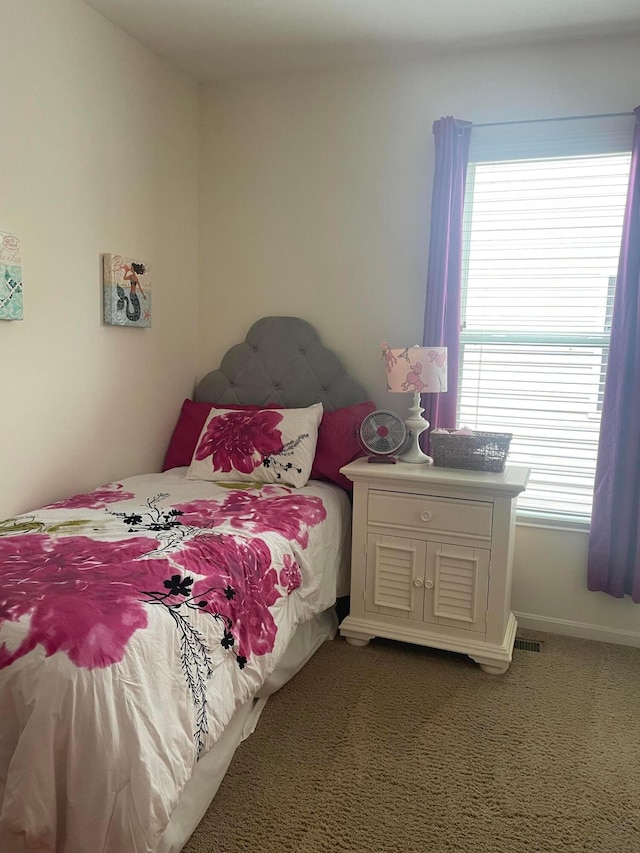 bedroom with carpet floors, baseboards, and visible vents