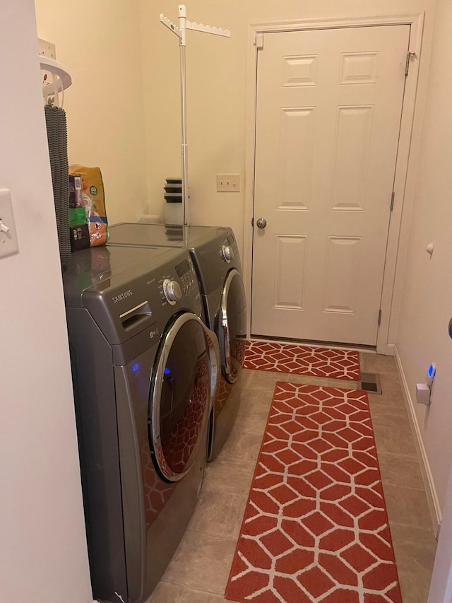 laundry area featuring washer and dryer, laundry area, tile patterned flooring, baseboards, and visible vents