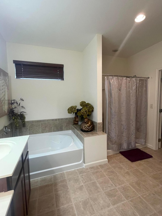 bathroom featuring a shower with curtain, a garden tub, and vanity