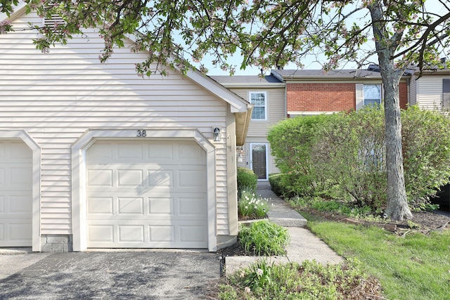 38 Ravine Ridge Dr S, Powell, OH 43065 - view of front of house featuring brick siding, driveway, and a garage