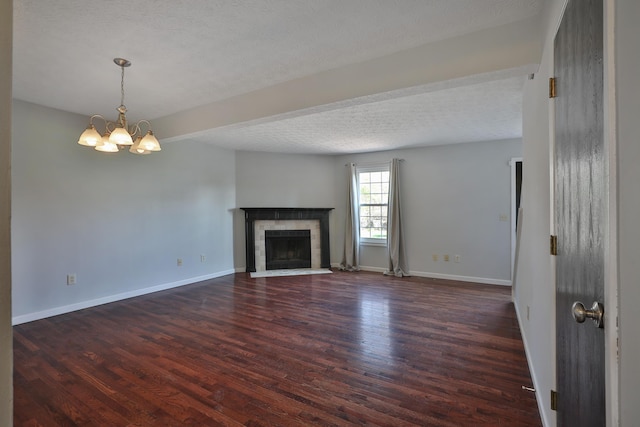 38 Ravine Ridge Dr S, Powell, OH 43065 - unfurnished living room with wood finished floors, a fireplace, baseboards, a chandelier, and a textured ceiling