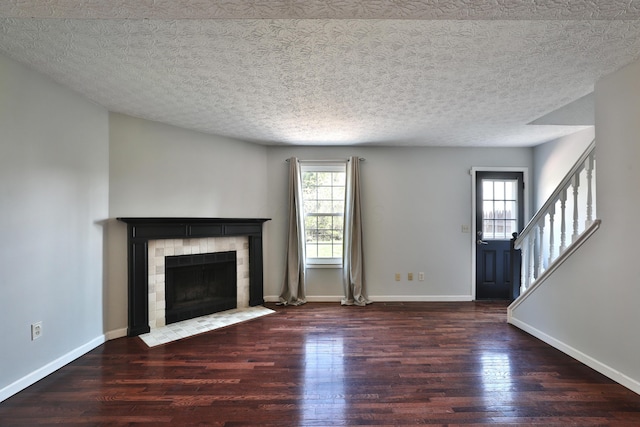 38 Ravine Ridge Dr S, Powell, OH 43065 - unfurnished living room featuring a fireplace, wood finished floors, a wealth of natural light, and baseboards