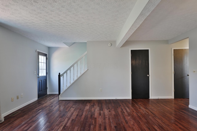 38 Ravine Ridge Dr S, Powell, OH 43065 - unfurnished living room with baseboards, wood finished floors, a textured ceiling, and stairs