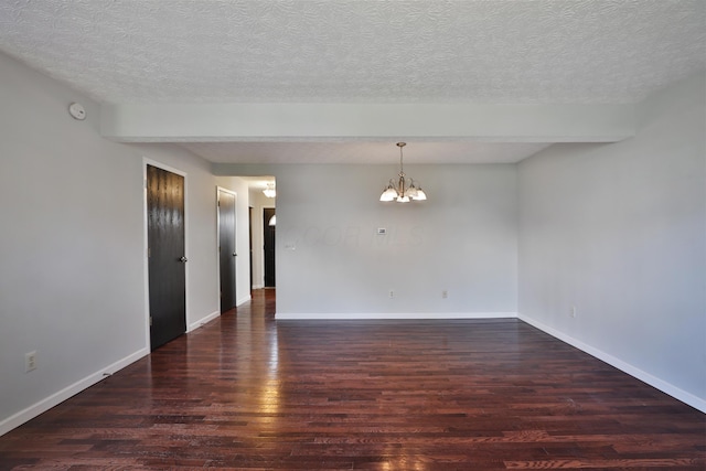 38 Ravine Ridge Dr S, Powell, OH 43065 - spare room featuring a chandelier, baseboards, wood finished floors, and a textured ceiling