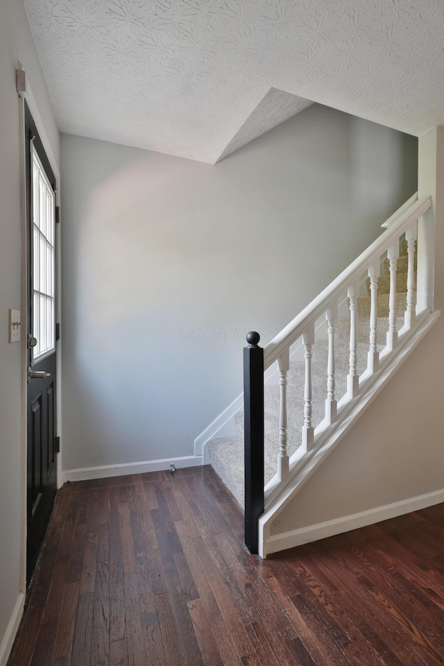 38 Ravine Ridge Dr S, Powell, OH 43065 - stairs featuring wood finished floors, a textured ceiling, and baseboards