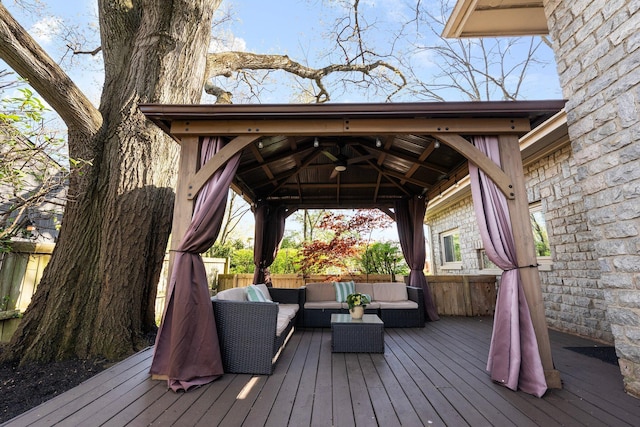 wooden deck with a gazebo and an outdoor hangout area
