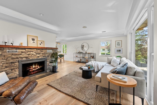 living area featuring baseboards, wood finished floors, a fireplace, and recessed lighting
