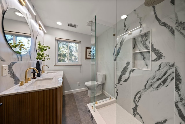 bathroom with visible vents, toilet, vanity, and a marble finish shower