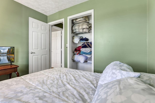 bedroom with a closet and a textured ceiling