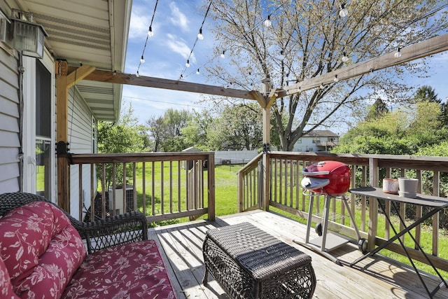 wooden terrace with a lawn