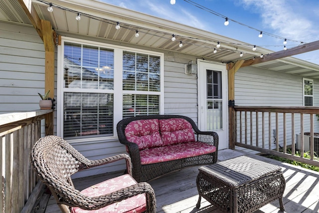 wooden deck featuring central air condition unit