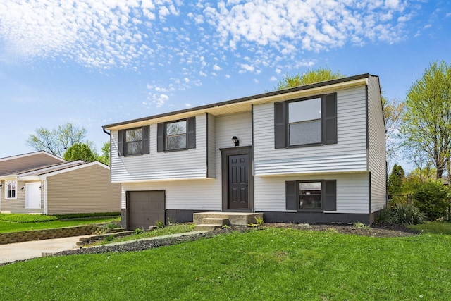 5930 Parkglen Rd, Galloway, OH 43119 - split foyer home with concrete driveway, a front lawn, and a garage