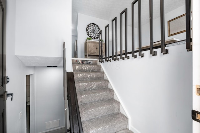 5930 Parkglen Rd, Galloway, OH 43119 - stairway with a textured ceiling and visible vents