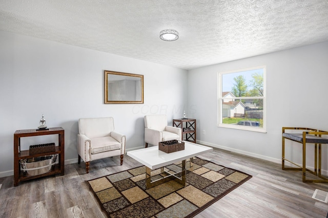 5930 Parkglen Rd, Galloway, OH 43119 - living area with baseboards, wood finished floors, and a textured ceiling