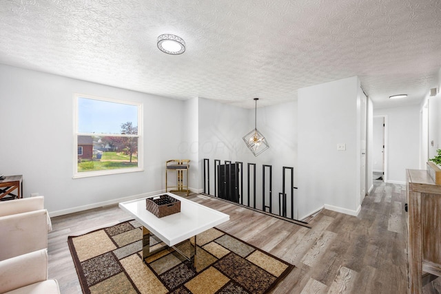 5930 Parkglen Rd, Galloway, OH 43119 - living room with baseboards, wood finished floors, and a textured ceiling