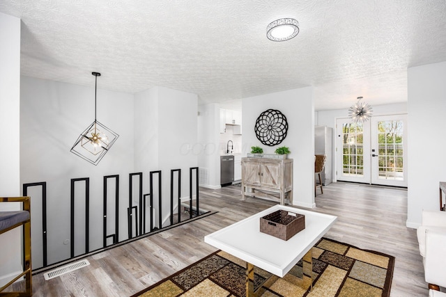 5930 Parkglen Rd, Galloway, OH 43119 - living area featuring wood finished floors, a textured ceiling, and visible vents