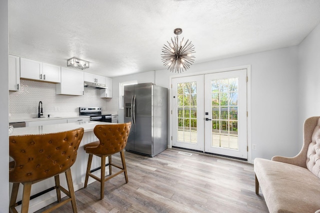 5930 Parkglen Rd, Galloway, OH 43119 - kitchen featuring stainless steel appliances, french doors, a sink, backsplash, and light countertops