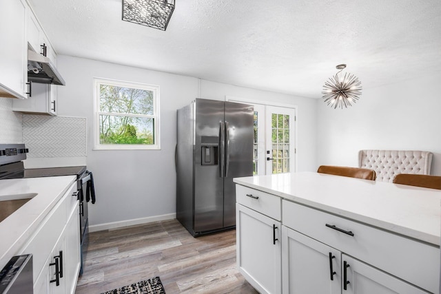 5930 Parkglen Rd, Galloway, OH 43119 - kitchen with under cabinet range hood, electric stove, light wood-type flooring, a wealth of natural light, and stainless steel refrigerator with ice dispenser