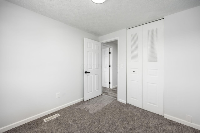 5930 Parkglen Rd, Galloway, OH 43119 - unfurnished bedroom with a textured ceiling, baseboards, visible vents, a closet, and carpet floors