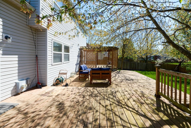 deck featuring a fenced backyard, a pergola, and an outdoor hangout area