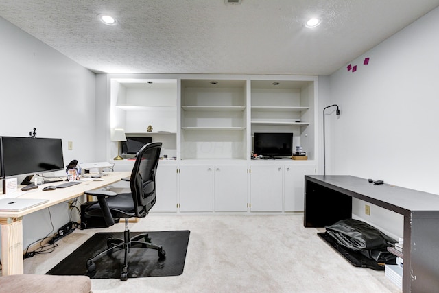 office area with a textured ceiling, recessed lighting, and light colored carpet