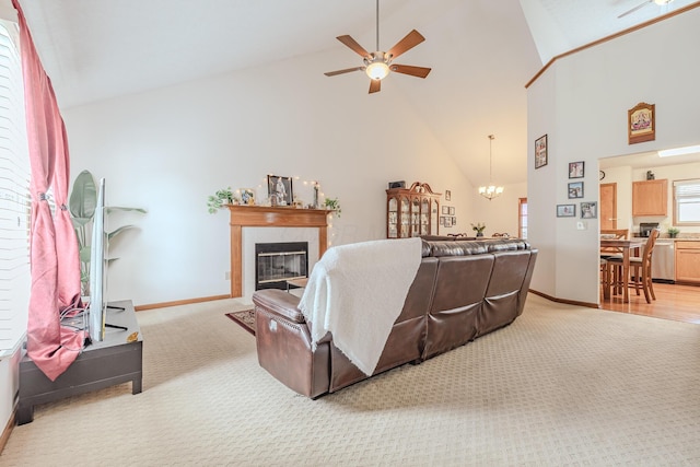 730 Erin St, Lewis Center, OH 43035 - living area featuring a tiled fireplace, high vaulted ceiling, light carpet, and ceiling fan with notable chandelier