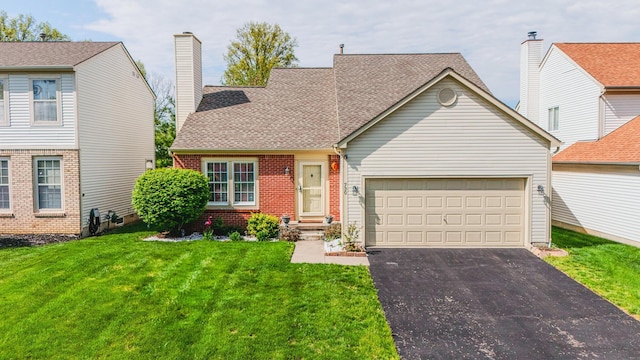 730 Erin St, Lewis Center, OH 43035 - view of front of property with a shingled roof, an attached garage, brick siding, aphalt driveway, and a front yard