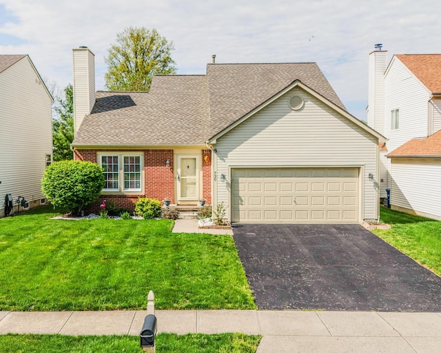 730 Erin St, Lewis Center, OH 43035 - view of front facade with aphalt driveway, a front yard, brick siding, a shingled roof, and an attached garage