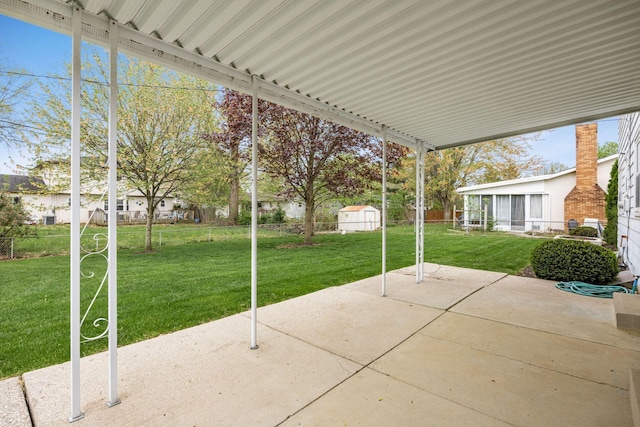 view of patio / terrace with an outdoor structure and a storage unit