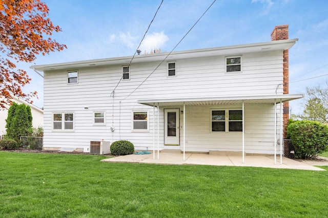 back of property with a chimney, fence, a patio, central AC, and a lawn