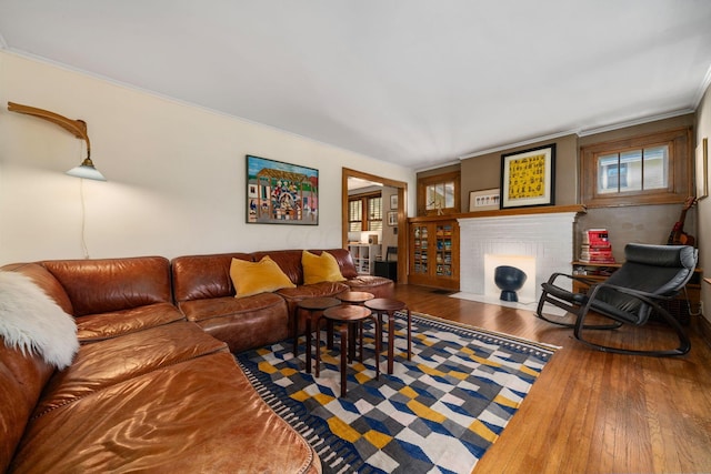 1397 Glenn Ave, Columbus, OH 43212 - living room featuring wood-type flooring, a brick fireplace, and ornamental molding