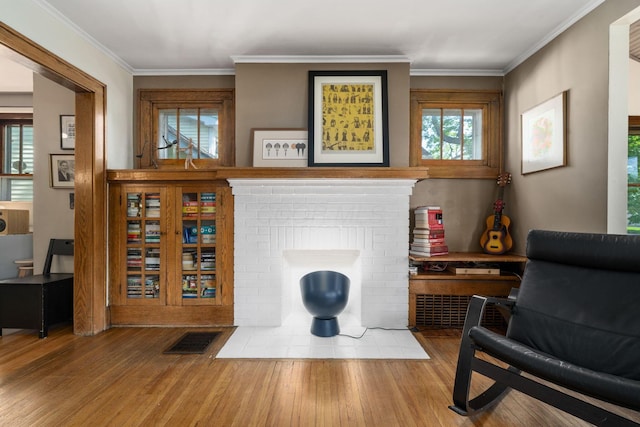 1397 Glenn Ave, Columbus, OH 43212 - living area with wood finished floors, ornamental molding, and a fireplace