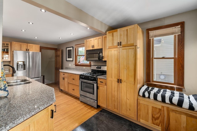 1397 Glenn Ave, Columbus, OH 43212 - kitchen with appliances with stainless steel finishes, a sink, light wood-type flooring, dark stone counters, and recessed lighting