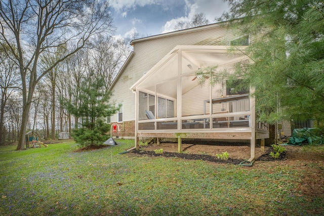 6181 Perry Rd, Centerburg, OH 43011 - rear view of house with a lawn, a sunroom, and a playground